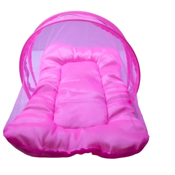 view of pink baby bedding set with mosquito net and 3 pillows